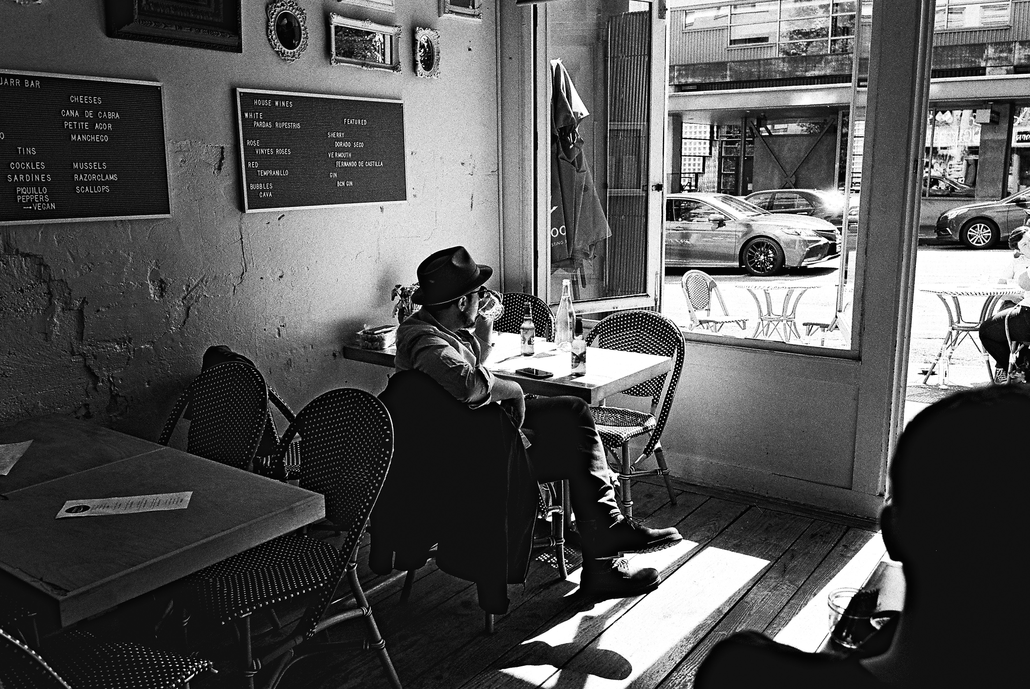 Man at wine bar, afternoon light